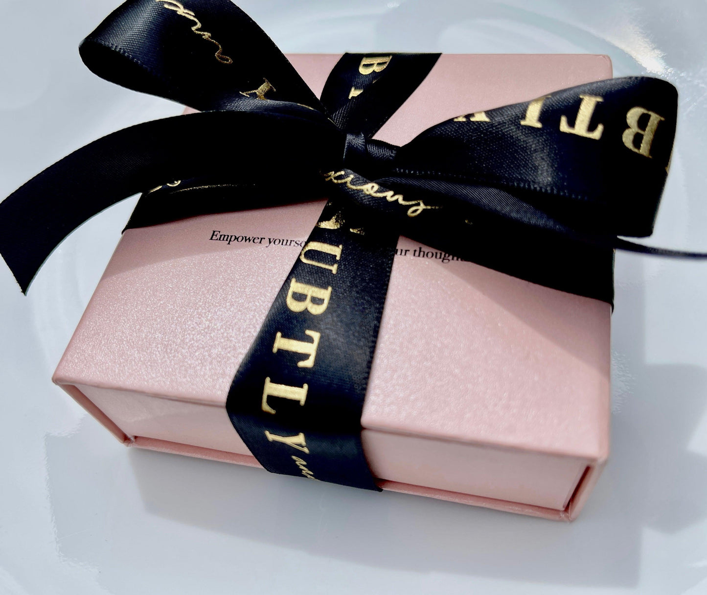 Luxury giftbox with black ribbon and canvas pouch subtly anxious 