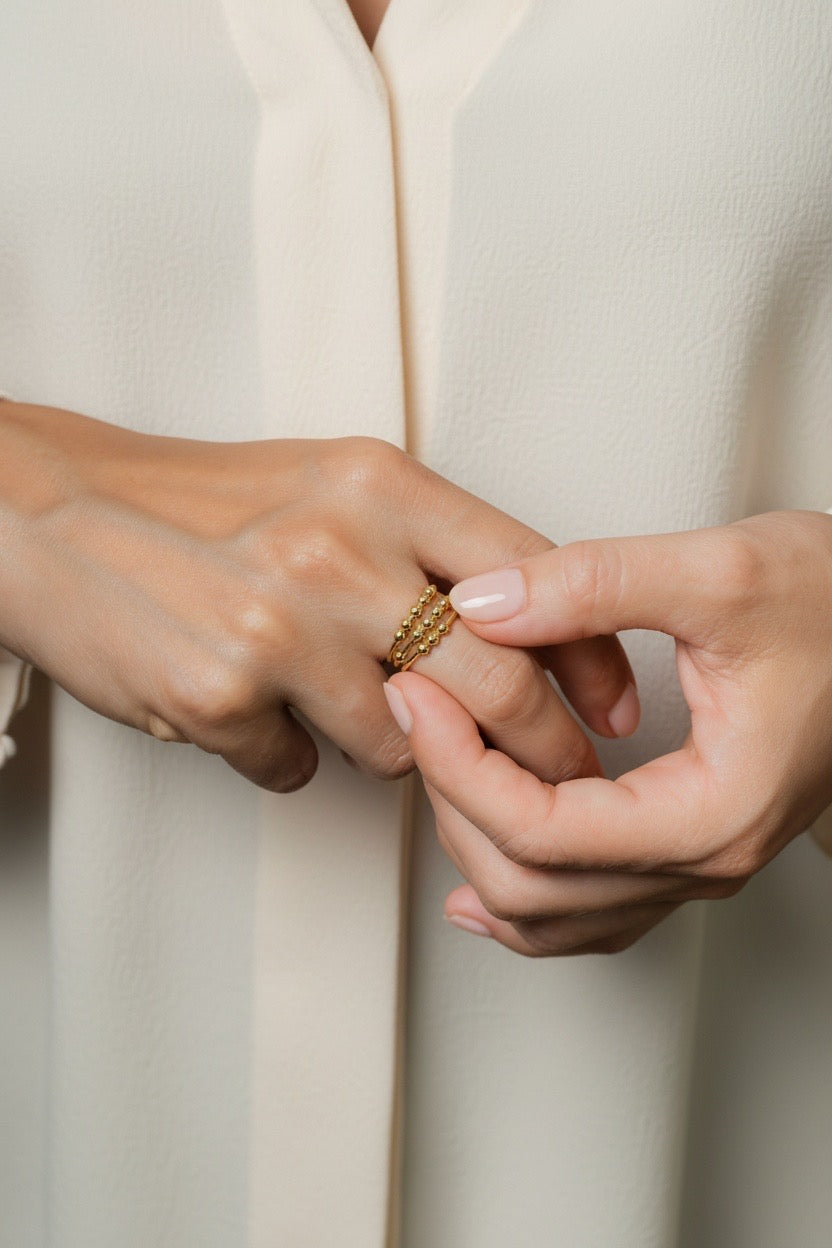 Close up of woman wearing three fidget rings stacked
