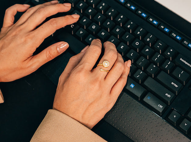 Woman wearing anxiety ring typing on computer 